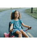 Child enjoying a ride on a pink hoverboard seat attachment for kids and grownups, go kart attachment for self balancing scooters.