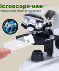 Hand placing slide under microscope from Awesome 30 Prepared Microscope Slides With Specimens For Biology Labs Includes Plants Algae