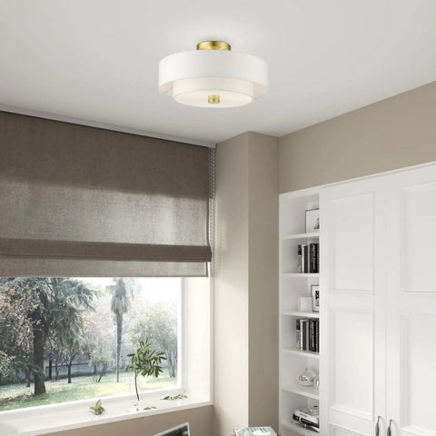 Meridian Collection 3 Light Satin Brass Semi Flush Mount Ceiling Light With Off White Hardback Fabric Shade in a modern room
