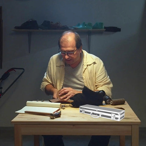Solid Aluminum Tool Box Featuring A Slick Padded Interior And Extra Sturdy Reinforced Handle on a table with tools.