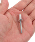 Single aluminum rivet from 140 Piece Aluminum Blind Rivets Kit for Auto and Furniture Repair held in hand
