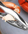 Complete 21 Piece Seafood Tools Set With Six Crab Crackers holding crab claw on grey plate
