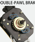 Front view of manual lever chain hoist drive assembly with brass gear, blue pawl levers, black housing