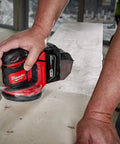 Slick Cordless Random Orbit Sander Kit With M18 Battery Pack for smooth wood finishing on a job site.
