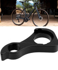 Rear Derailleur Hanger CC1117 CNC Compatible With Giant Revolt Series Bikes next to a black bike on a stone floor