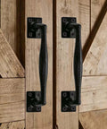 Two Pack Heavy Duty Cast Iron Barn Door Handles Nine And Three Quarters Inches Rustic Gate Pulls For Garage Outdoor Closet Interior Black Tough As Nails Durable Rust Resistant Long Cabinet Handles mounted on wooden barn doors