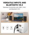 Laptop setup with M60 Desktop Bluetooth Speaker With 66W RMS Output, USB-C and AUX connectivity, oak finish, and LDAC support