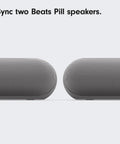 Two Beats Pill speakers shown side by side on a light background.