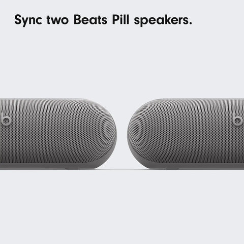 Two Beats Pill speakers shown side by side on a light background.
