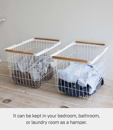 Two Tosca Laundry Basket With Wooden Handles Medium 11 Inch Steel And Wood Durable Rectangular Laundry Hamper With Ample Interior Space For Clothes 6 Gallons 23 Liters filled with laundry on a wooden floor.