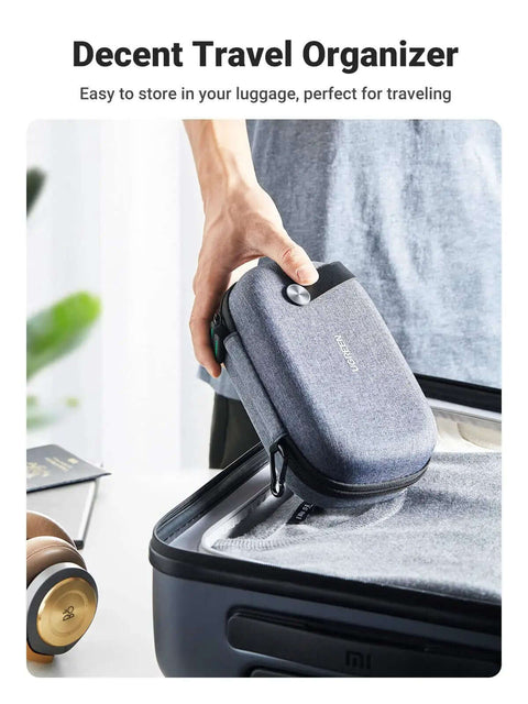 Rugged Hardshell Tech Organizer Travel Case Packs All Your Fresh Gadgets Square With Nifty Double Layer Pouch For Cables Chargers And Memory Cards In Sleek Space Grey being lifted from luggage.