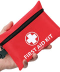 Red fabric mini first aid kit pouch, front view with black zipper and white cross emblem