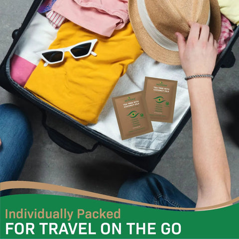 NOVEHA eyelid and lash wipe sachets with tea tree and coconut oil; travel-friendly, 2-pack shown in suitcase