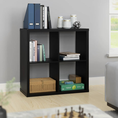 Open Back 4 Cube Storage Organizer In Black Built With A Sturdy Frame And Finished On Front And Back Perfect For Living Room Or Closet Organization Accepts 13 Inch Fabric Bins Easy Assembly showing four cubes with books and decor items.