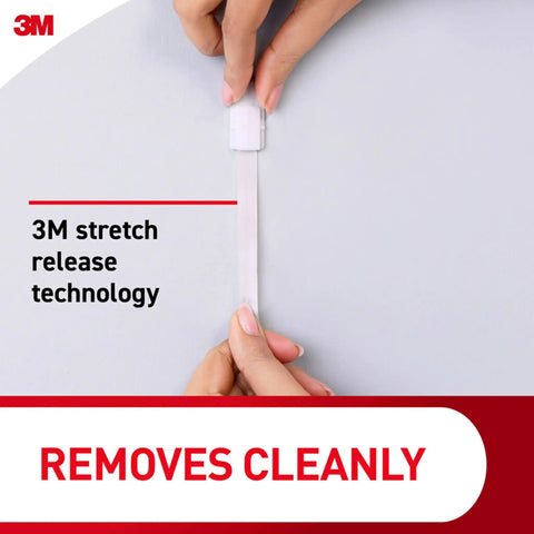 Removing adhesive strip for Five Pound Large Brushed Nickel Metal Hooks With Two Large Hooks And Four Adhesive Strips Damage Free Hanging.