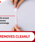 Person demonstrating adhesive removal from wall showing Oil Rubbed Bronze Metal Hooks Set With Two Coat Hooks And Four Adhesive Strips Holds Up To Five Pounds Damage Free Hanging No Nails No Holes Easy Install For Home Or Room Decor And Organization with stretch release technology.