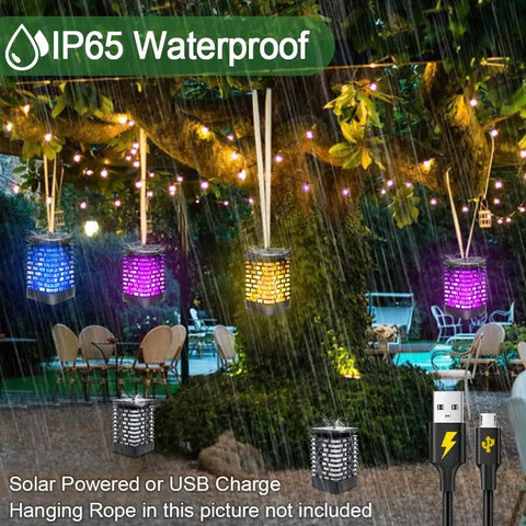 Cool Blue Dancing Flame Solar Lantern Lights Outdoor Waterproof 99LED Hanging Lantern USB Or Solar Powered Yard Patio Deck Garden Decor 2 Pack Great For Parties Camping BBQs Christmas Or Halloween Outdoor Decor hanging in garden during rain.