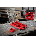 Open Packout Compact Low-Profile Tool Organizer With Transfer Tank Storage on workbench, holding small tools and parts.