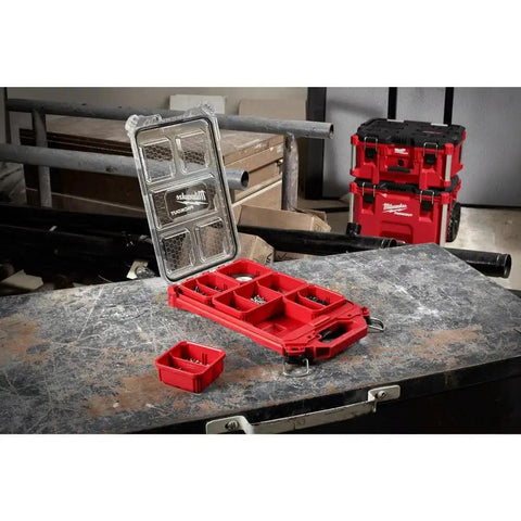 Open Packout Compact Low-Profile Tool Organizer With Transfer Tank Storage on workbench, holding small tools and parts.