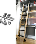 Complete Heavy Duty Sliding Barn Door Hardware Kit Featuring All In One Black Steel Track With Smooth Gliding Rollers For No Sweat Loft Installation Indoors displayed with wooden ladder and accessories.