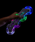 Close-up of Glowrider 92A Inline Skate Wheels With Magnetic LED Lights and Bearings, 80mm lit up in Eternal Blue, held in hand.
