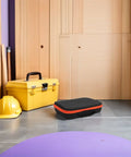 Rugged EVA Tool Storage Case For Drill Driver And Grinder with yellow toolbox, hard hat in a wood-paneled room