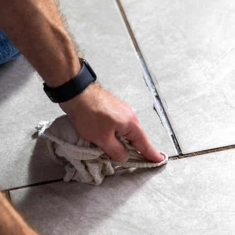 Applying Tile Grout Repair Gray Squeeze Tube 5.5 Ounce Pre Mixed Ready To Use Formula to ceramic tile grout line