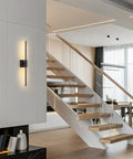 Slick Black Cordless Wall Sconces Set Of Two Wireless Led Accent Lamps With Smooth Stepless Dimming And Handy Remote Zero Wiring Hassle Modern Lighting For Bedrooms Hallways shown beside modern staircase.