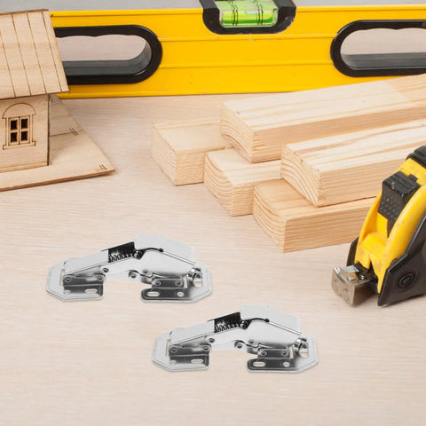 Heavy Duty Stainless Steel Cabinet Door Hinges Featuring Killer Soft Close Hydraulic Buffer Damper For Wardrobes And Cupboards Built Like A Tank And Slick. Two hinges on workbench with tools.