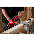 Man using M18 FUEL Hatchet 8 Inch Pruning Saw Bare Tool Only on wood, compact ergonomic grip shown, no battery