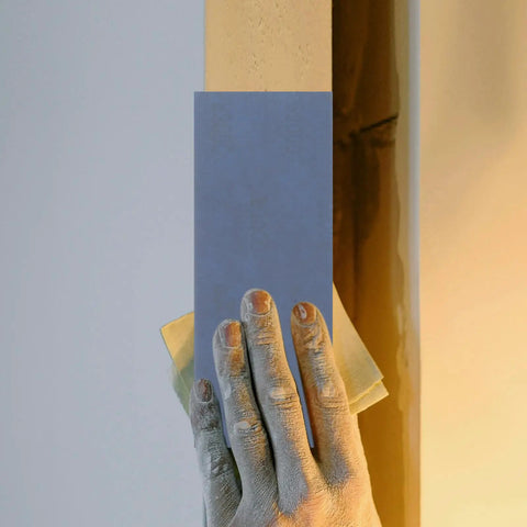 Hand using Wet And Dry Sandpaper Sheets Kit With Silicon Carbide Grit For Metal Wood Furniture Cars And Electronics 36 Pro Grade Pad