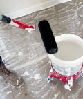 9-Inch Drywall Compound Roller Frame For 9-Inch Corner Roller Covers in use, applying joint compound from bucket