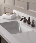 Haywood Widespread Bathroom Faucet in Brushed Nickel, 3-hole sink setup with included drain assembly, water flowing from faucet