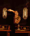 Vintage Gold Wall Mounted Candle Sconce With Mirrored Backplate And Floral 3D Woven Texture For Bathroom Or Living Room Certified Prime Real Estate Home Decor Accessory That Elevates Your Daily Vibes Always lit with candle in elegant setting.