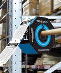 Flat Out Dependable Inspection And Status Record Tags By The Roll Including A Portable Octagon Dispenser and perforated tags in a warehouse.
