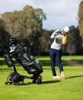 No Drama All Terrain Remote Electric Golf Cart With Full Zip Folding Frame Plays Thirty Six Holes Smooth Operator on grassy course.