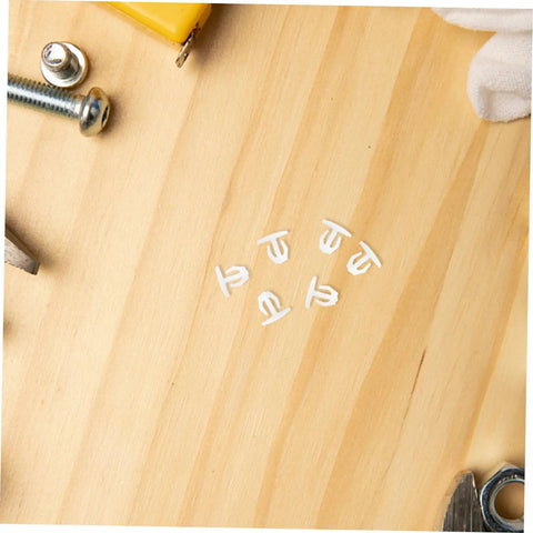 Anchor-Shape LED Strip Clips White Plastic Mounting Brackets For LED Light Strips on wooden surface with tools visible