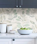 Kitchen scene with Fable Leaf Peel And Stick Wallpaper In White And Off White Floral Peelable Wall Covering behind green apples.