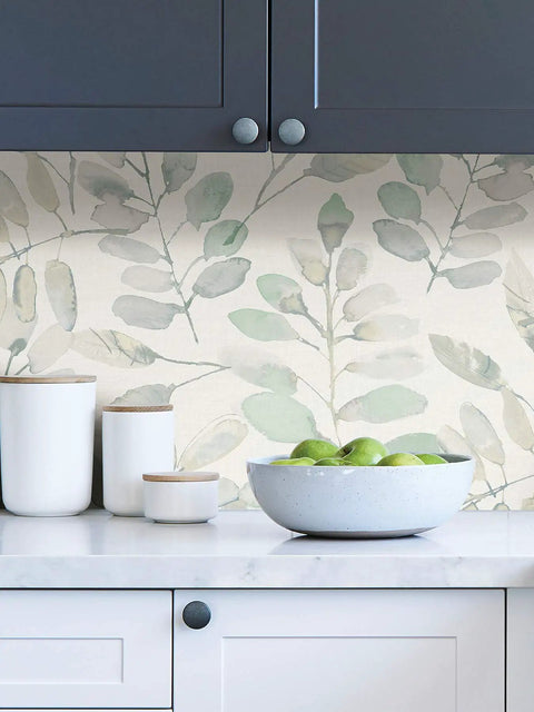 Kitchen scene with Fable Leaf Peel And Stick Wallpaper In White And Off White Floral Peelable Wall Covering behind green apples.