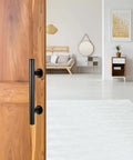 12 Inch Sliding Barn Door Handle Pull with Flush Back Plate, Matte Black Powder Coated Finish, installed on wooden interior door