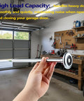 Person holding 2-Pack 9 Inch Long Stem Steel Garage Door Roller for 2-Inch Track in a garage, showing heavy-duty construction.