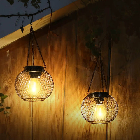 Auto On Solar Lanterns For Outdoors Upgraded Hanging Garden Lights Metal Waterproof Lanterns glowing at night on wood wall