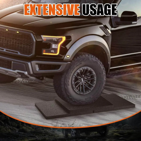 Truck parked on Universal Twelve Inch RV Stabilizer Jack Pads Rubber Non Slip Flex Blocks preventing sinking on uneven ground.