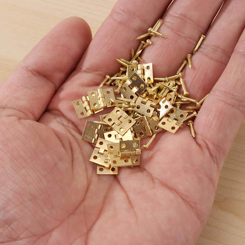 100 Pack Mini Hinges With 400 Replacement Screws In Gold Copper Finish Four Hole Butt Hinges 10x8mm in hand, for jewelry cases.