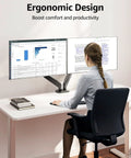Woman using dual monitor desk arm mount for 22 to 32 inch screens height adjustable VESA 75x75 or 100x100 at ergonomic desk