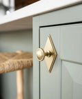 Slick Champagne Bronze Cabinet Knobs Pairing Fresh Rhombus Backplates With Fluted Dome Heads Brings Top Shelf Style To Your Kitchen Remodel Or Bathroom Refresh Alongside Three And A Half Inch Size Including A Set Of Six Go To Picks on a green cabinet.