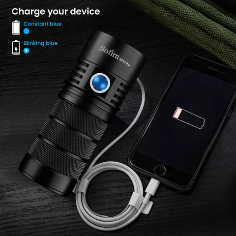 SP36 Pro Rechargeable LED Flashlight 8000 Lumens, 4X SST40 6500K charging a smartphone via USB cable on a dark surface.