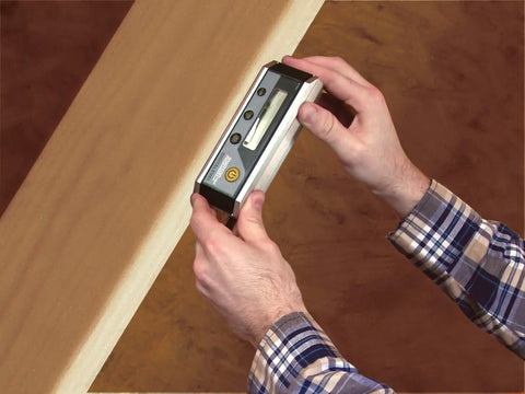 Person using Magnetic Digital Level 6 Inch With Auto Inversion For Overhead Readings on wood surface