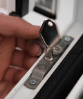 Heavy Duty Die Cast Metal Release Key That Works Like A Champ For Detachable Window Restrictor Stays And Replacement Hardware Tools With Smooth Mill Finish Look in use on a window restrictor.