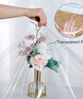 Transparent PVC vinyl table cover overlaying a floral arrangement to demonstrate material thickness and flexibility.